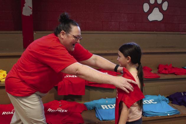 Project RESPECT Mental Health Provider Crystal Simonds holds a Roaree T-shirt up to Earlsboro Elementary student Pazlei Fry.