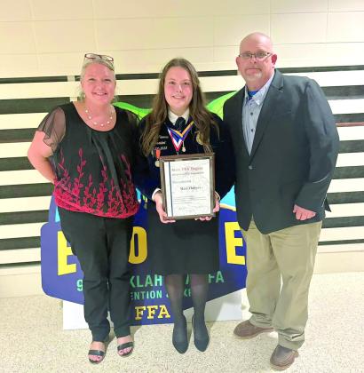 Tecumseh graduate Maci Flowers poses with her State FFA Degree and her parents, Sarah and Steve Flowers, during the Oklahoma State FFA Convention earlier this month. With her degree, Flowers also received an Academic Excellence recognition. Plus, she accepted a Career Passport in Ag Communications at the convention. Photo provided.
