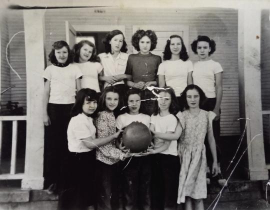 A girls basketball team at New Hope School poses in front of the school. Shown, front row from left, is Ina Nell Brown, Linda Carol Barnes, Christine Junk, Glorene Carter, Gerry Bowers, back row, _, _, _, _, Mary Porter and Mary Junk. Photo provided.