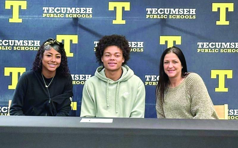 Tecumseh senior Jekhi Owens poses with his family, Jazz Owens, left, Owens, and Tedda Hogan, right, after signing a letter of intent for football at Northeastern Oklahoma A&amp;amp;M College on Feb. 4. Photo provided by Tecumseh Public Schools