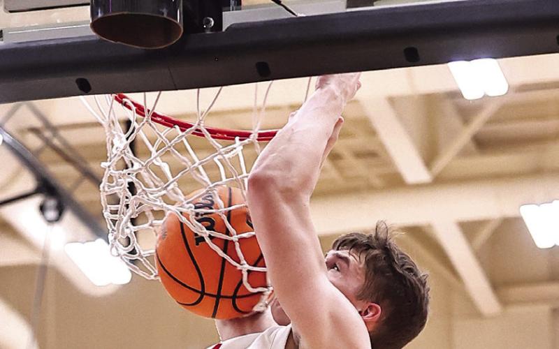 Landon Rosser dunks for two in the district championship game against Seminole on Feb. 21.