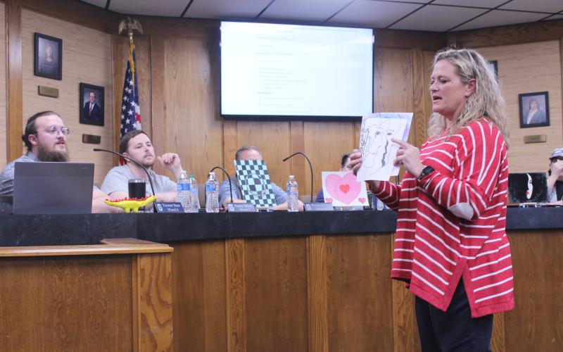 Jefferson Elementary Principal Jennifer Epperley explains one of the six student art pieces she brought to show the Shawnee Board of Education on Feb. 9.
