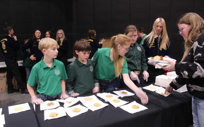 4-H Club Members Jackson Moreland, Talow Sumner, Ryleigh Guderian, and Kylee Townsend assist with the dessert line during the 37th Annual Pottawatomie County Junior Livestock Show (PCJLS) Pig Roast and Trophy Auction, held at FireLake Arena on Feb. 2. Natasha Dunagan, Countywide &amp; Sun