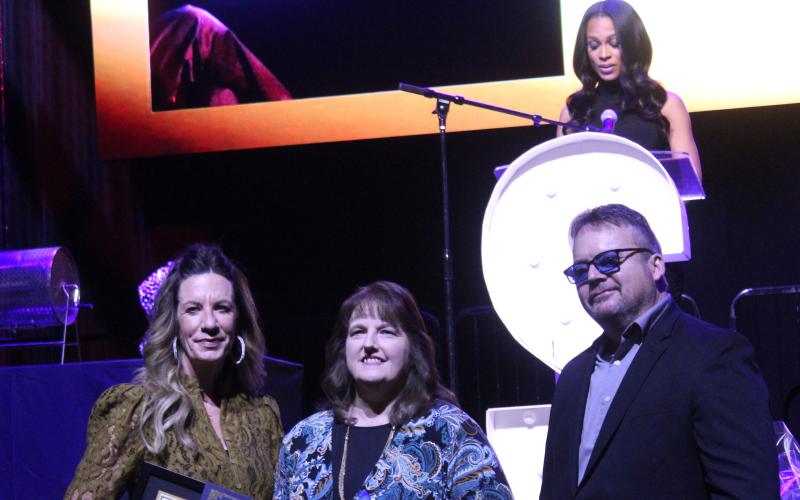 Sandra Herron received the Civilian Employee of the Year Award for going above and beyond working in the Shawnee Police Records Department during the Shawnee Police Foundation Annual Banquet, held at the Grand Casino Hotel and Resort on Jan. 30. Presenting the award are SPF Chairman Melissa Stuteville and Police Chief Mason Wilson.