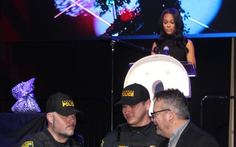 Shawnee Police Chief Mason Wilson, far right, shakes hands with Officer Michael Azevedo, after Azevedo and Officer Jarrett Thorpe received Life-Saving Awards for saving a man's life on Jan. 9, 2025, during the Shawnee Police Foundation Annual Awards, held at the Grand Casino Hotel and Resort on Jan. 30. KOCO Channel 5 News Anchor Kylie Walker, on stage, was the emcee for the evening.