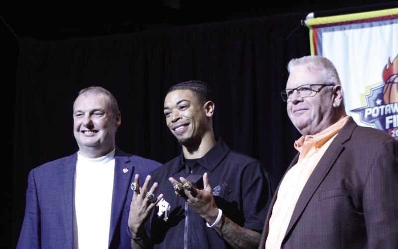 Potawatomi Fire Guard Chuck Guy accepts another ring as two-time TBL MVP during the Third Annual 2025 TBL Championship Banquet and Ring Ceremony at FireLake Arena on Feb. 19. Also shown are, left, Head Coach Mark Dannhoff and, right, FireLake Arena General Manager David Qualls. Natasha Dunagan, Countywide &amp; Sun