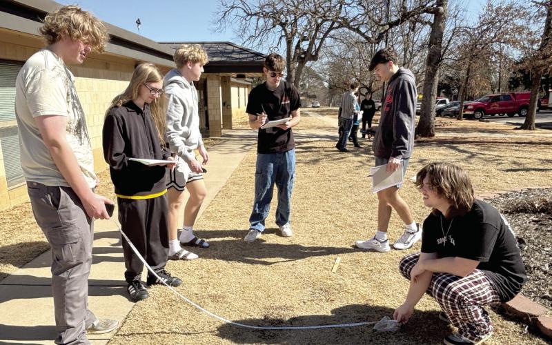Tecumseh Forensic Criminology students Jackson Lindamood, Gavin Borboa, Jace Musgrave, Wyatt Heck, Tristan Baney, and Jacob Holmes practice taking proper measurements of evidence as part of their outdoor lab. Cheyanna Dietz, THS Intern