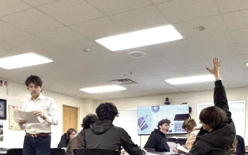 Justin Wood, Communications Director for Tecumseh High School, passes out study guides for the ACT Workshop held during Savage Time this year. Cheyanna Dietz, Intern