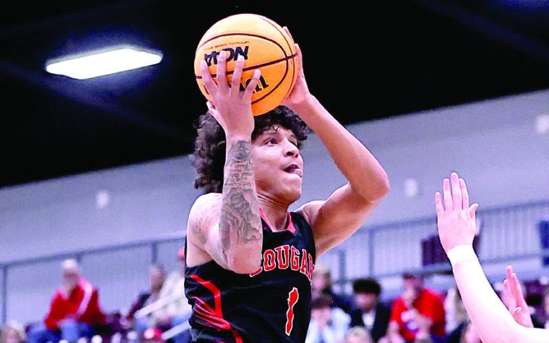 NRC's Memphis Burdine slams his layup in the Area Championship game against Catoosa where they won, 69-54. Photo Courtesy of Gowin Photography
