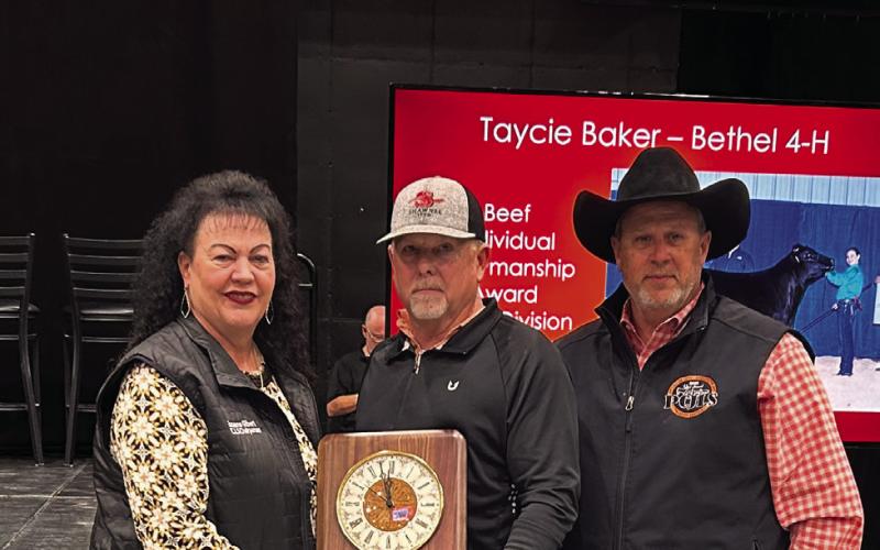 Suzanne Gilbert (left) and Matt Griffith (right) present an award to Brent Dugan (center) as he is recognized for his years of service to the ag youth and the Pottawatomie County Junior Livestock Show. Suzie Campbell, Countywide &amp; Sun