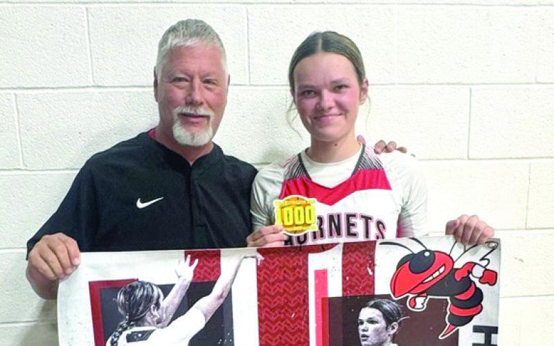 Macomb sophomore Adilyn Beauchamp achieved her 1,000th point on Jan. 30 in the game against Butner. She is shown here with Head Coach James Hancock. Photo provided