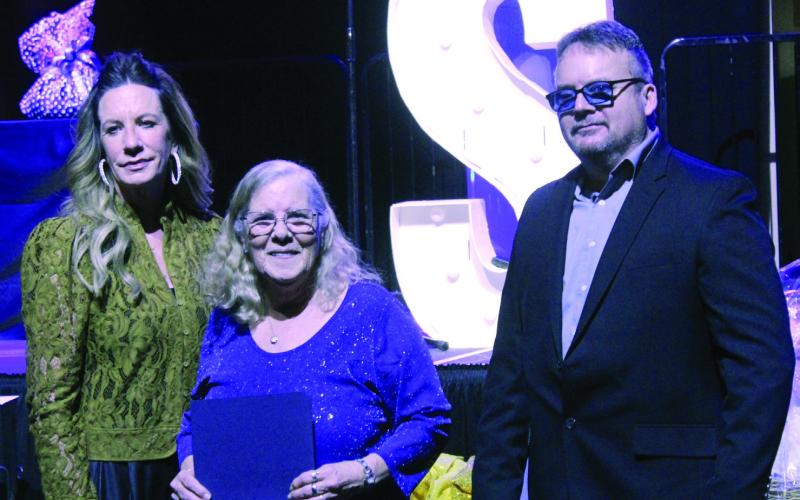 Debbie Christian, with the Volunteers in Police Service (VIPS), accepts the VIP of the Year Award during the Shawnee Police Foundation Annual Banquet, held at the Grand Casino Hotel and Resort on Jan. 30. Presenting the award are Shawnee Police Foundation Chairman Melissa Stuteville and Shawnee Police Chief Mason Wilson. Natasha Dunagan, Countywide &amp; Sun