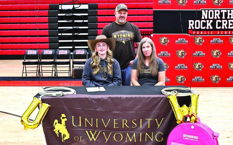Lexi Helmick signs with University of Wyoming rodeo, with her parents Sam &amp;amp; Melissa Helmick. Photo Courtesy of Gowin Photography
