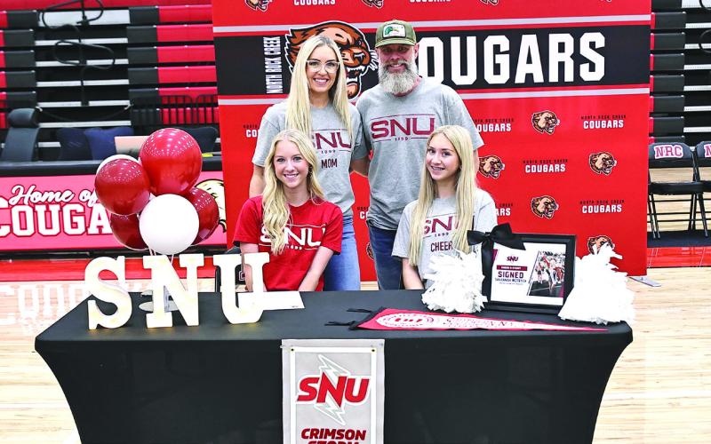 Savannah Motrych signs with SNU cheer, with her parents, Kaylin &amp;amp; Jason, and sister Amber Motrych. Photo Courtesy of Gowin Photography