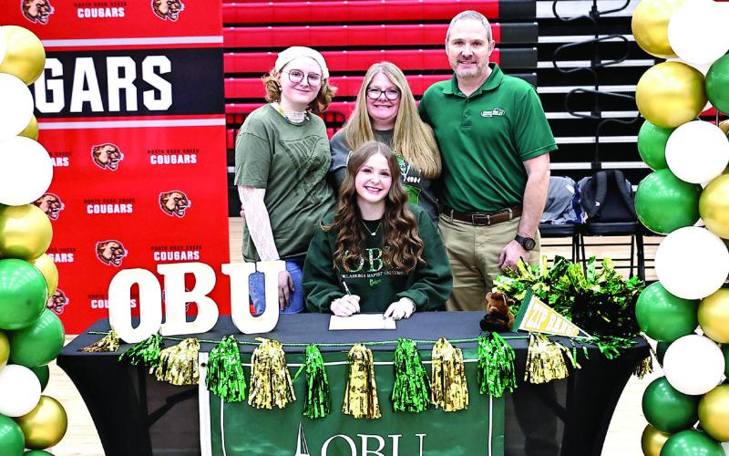 Makayla Kipps signs with OBU cheer, with her parents, Stacy &amp;amp; Jimmy Kipps, and her sister. Photo Courtesy of Gowin Photography