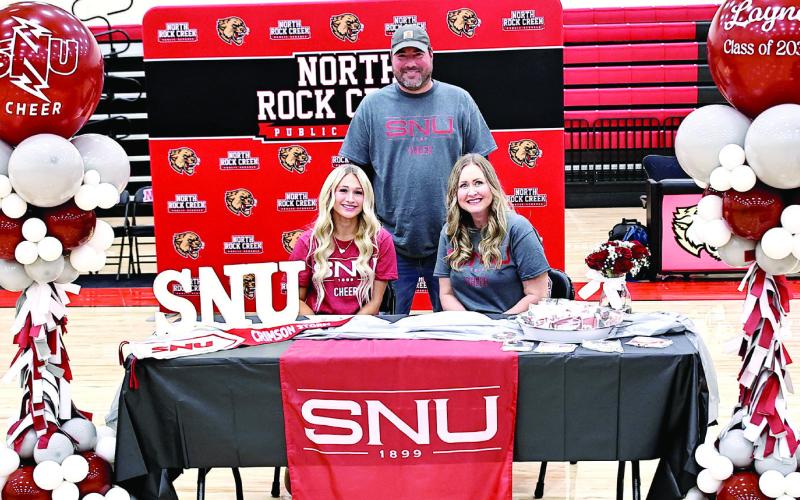 Laynee Joyner signs with SNR cheer, with her parents Nick &amp;amp; Kristi Gouker. Photo Courtesy of Gowin Photography
