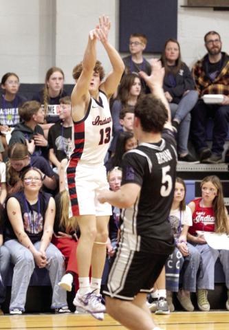 Asher's Pierce Aduddell sinks a trey in the Feb. 13 District home game against the Oklahoma School for the Deaf. The Indians won, 62-38, and advanced to Regionals at Maud on Tues., Feb. 17. The Lady Indians also won their District game that night and would play in Regionals.