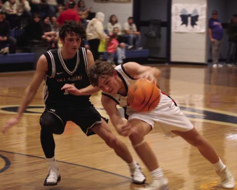 Asher's Hunter Francis guards the ball on his way up court.  Click on the camera banner ad below to see all of our photos from the game!