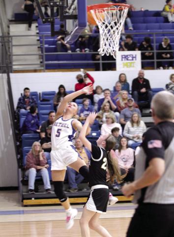 BHS junior Kinley Bowles makes a basket after stealing the ball during the second quarter of the Feb. 6 game against Tecumseh. Also shown is THS junior Chandler Bryant.
