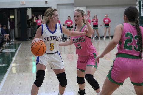 Bethel junior Brooklyn Duff looks to pass as she defends the ball from a Jones player during Pink Out Night on Feb. 13. The Lady Wildcats won, 44-41. Since then, on Feb. 17, they won the Class 3A District game at Okmulgee, 62-24. They will play in Class 3A Regionals today (Feb. 23) in Prague at 6 pm. Countywide &amp; Sun/Natasha Dunagan