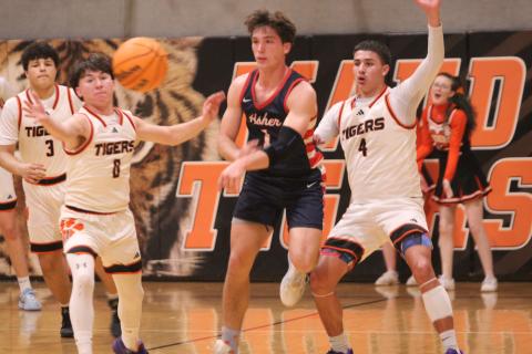 Asher junior Hudson Skender passes to a teammate, while surrounded by Maud Tigers, during the Class B2 Regional Tournament, held at Maud on Feb. 17.  Natasha Dunagan, Countywide &amp; Sun