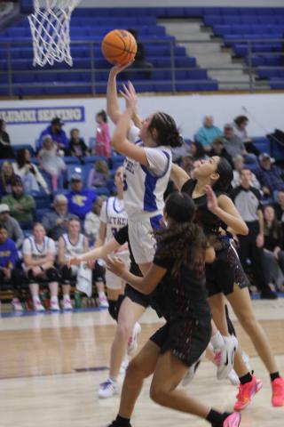 With an assist by Ava Gascon, Bethel senior Alexis Tucker makes a bucket in the Class 3A District Tournament home game against Lexington on Feb. 20. The Lady Wildcats advanced to the Regional Tournament on Feb. 24 in Jones.  Natasha Dunagan, Countywide &amp; Sun