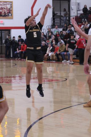 Tecumseh senior Aveon Stokes throws up a trey during the Class 4A District Tournament home game against Tecumseh on Feb. 21.