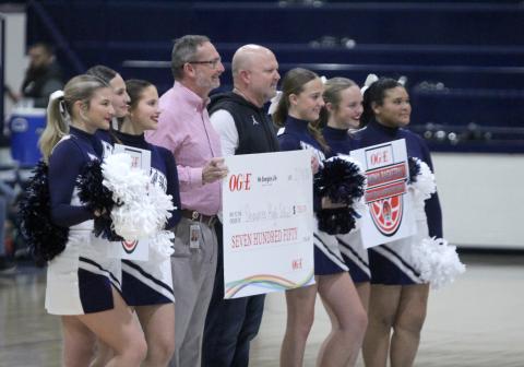 Shawnee Public Schools Athletic Director Dax Leone, fifth from left, and some of the SHS Cheerleaders accept a check from OG&amp;E for $750 to go to the basketball program during halftime of the Lady Wolves home game on Feb. 13. Natasha Dunagan, Countywide &amp; Sun