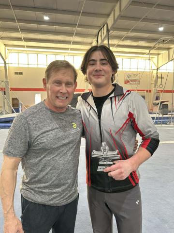 Bart Conner poses with senior Masen Steffens  as he receives the Level 10 Spirit Award, during the Bart Conner Invitational Gymnastics Meet held in Norman on Feb. 8. Steffens, 17, who has competed at Conner's gym for 10 years, is the son of Amy and Brandon Steffens of OkC and grandson of Gayle and Dave Gilmore of Shawnee. Photo provided