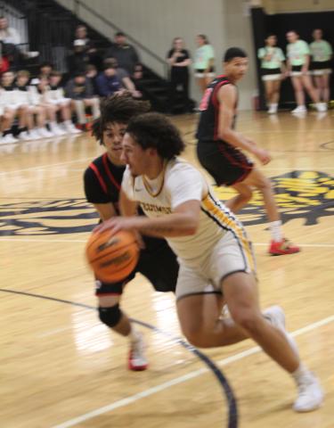 Tecumseh senior Aveon Stokes drives to the hoop during the Feb. 3 home game against McLoud. The Savages won 70-64 in overtime.