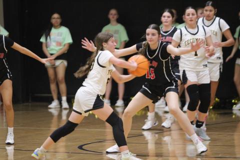 Tecumseh sophomore Sosi Mitchell passes around during the fourth quarter of the Feb. 3 home game with McLoud. The Lady Savages lost 20-83.