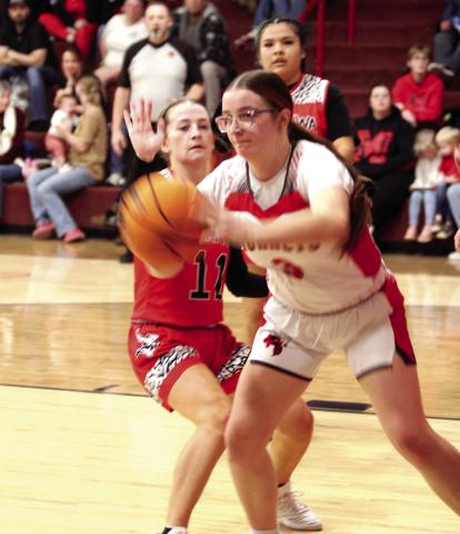 Macomb's Deja Givens grabs the rebound and passes during the Feb. 10 home game against Sasakwa.