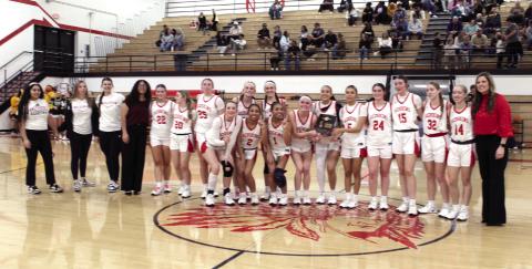 The McLoud Lady Redskins and their coaches pose with the Class 4A District Championship trophy after winning against Tecumseh on Feb. 21. They advanced to the Regional Tournament on Feb. 24 at home.