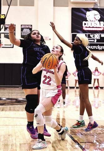 Kadence Munn goes between two defenders to add two in her 24-point game total against Mount St. Mary on Feb. 3. NRC won the home game 60-38. Photos Provided by Gowin Photography