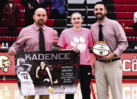Kadence Munn receives her banner and 1,000-point ball during the last home game with Head Coach Lance Blocker (left) and Asst. Coach Josh Ray (right).
