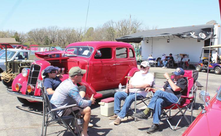 Bethel residents Steven Dodson, Karoline Dodson, Gary Goetz and Les Arnold have a conversation next to a 1935 Plymouth PJ in the Modified Pre-1970 Class at the Sixth Annual Bethel Band Boosters Car Show on April 9 at Bethel High School. Countywide &amp; Sun/Natasha Dunagan