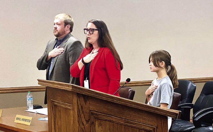 McLoud City Manager Cody Roe and Deputy Clerk Monica Poindexter recite the Pledge of Allegiance at the Aug. 28 McLoud City Council meeting. The pledge was led by special guest, 9-year-old Magnolia McClure (Mayor McClure's daughter). Julie Talton, Countywide &amp; Sun
