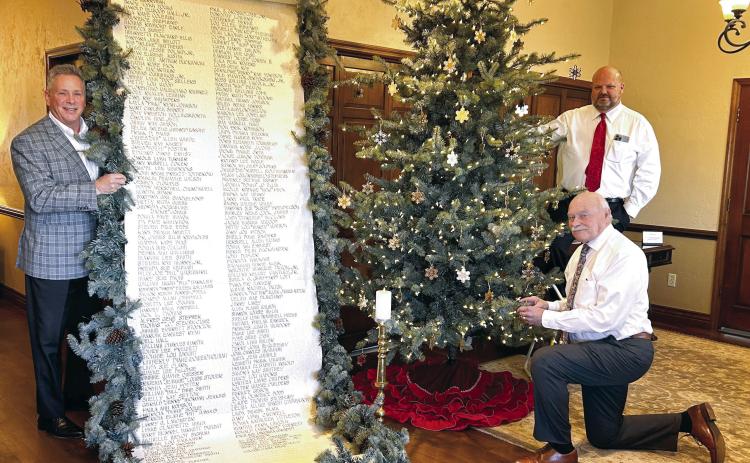 J. Cooper, Gary Schutten, and Landon Qualls pose with the Scroll of Honor and the Christmas Tree of Remembrance at Cooper Funeral Home in Tecumseh. Cooper Funeral Home will present “A Christmas Keepsake” program in the chapel for the 33rd year on Sunday, Dec. 8 at 2 pm. The families of those served by Cooper this year are invited to attend. Countywide &amp; Sun/Suzie Campbell