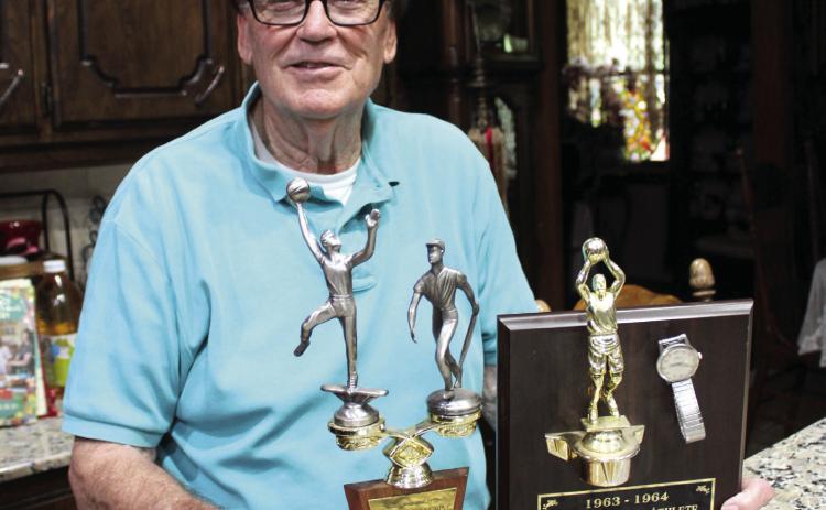 Former Dale Coach Harold Jones poses with two trophies from his youth: Most Outstanding Athlete from Bacone Junior College in 1961 and Most Valuable Athlete from East Central State University in 1963-64. Also shown are his four-time state champion coach's ring and National High School Girls Basketball Coach of the Year ring. Coach Jones will be inducted into the Oklahoma Coaches Hall of Fame on July 26. Natasha Dunagan, Countywide &amp; Sun