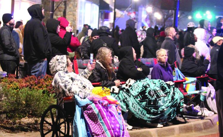 A large crowd came out to watch the 108 float entries in the Shawnee Parade of Lights on Dec. 13 amid the cold, mist and wind. File photo
