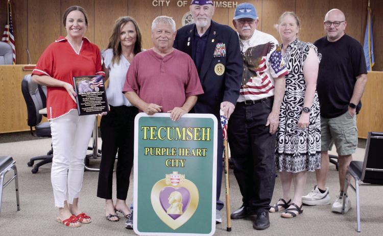 Tecumseh was officially designated as a Purple Heart City by Master Chief Larry VanSchuyver, Chapter 902 Commander of the Military Order of the Purple Heart, on Aug. 18 at Tecumseh City Hall. Shown, from left, are Natalie Arnett with State Farm Insurance; Ambassador Jessie Newell with Global Production Solutions; City Manager Jimmy Stokes; Master Chief Larry VanSchuyver; Mayor Eddy Parker; Coordinator Kacy Kinsey; and John Fletcher with Define Boutique. Arnett, Newell and Fletcher donated toward the signs.