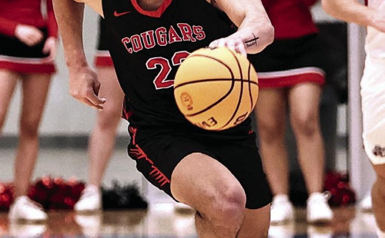 Nor th Rock Creek's Caleb Hawkins steals the ball and drives to the bucket. Photo courtesy of Gowin Photography