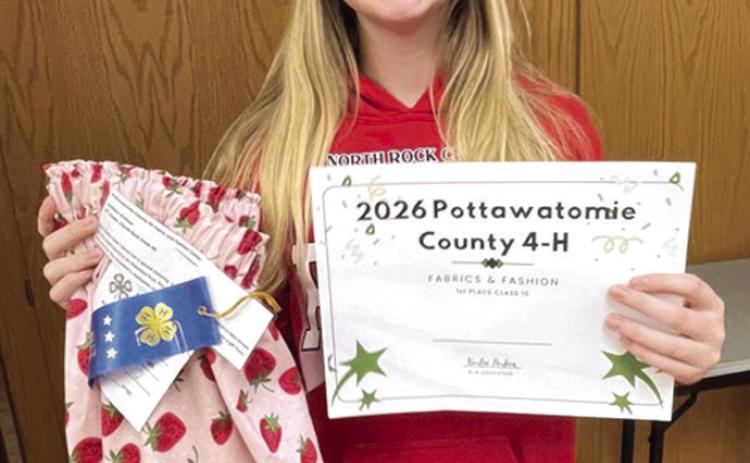 Addison Bristow holds her first place certificate alongside her strawberry patterned ribbon skirt. Photo provided by CPN