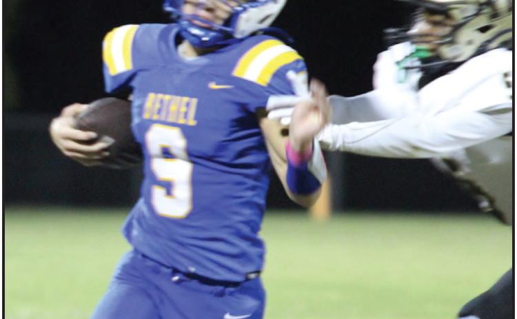 Bethel sophomore Maddox Davis tries to dodge being tackled while carrying the ball at the Oct. 4 home game with Hugo. The Wildcats lost, 24-38. File photo