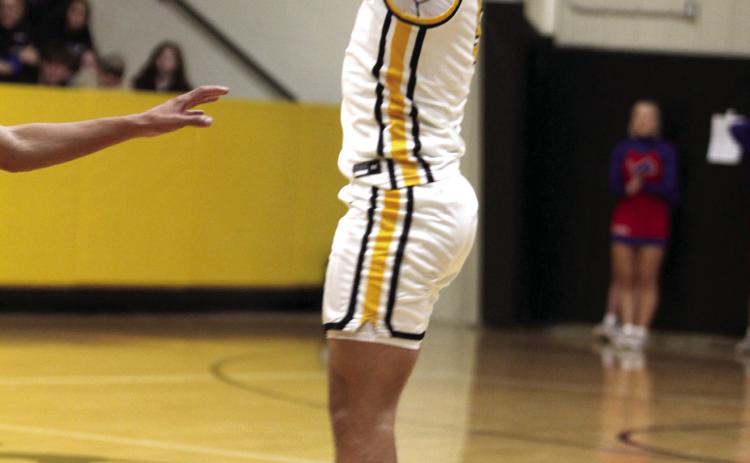 Tecumseh senior Aveon Stokes sinks a three-point shot in the Dec. 5 home game against Chandler. The Savages lost 74-81, and the Lady Savages lost 34-57 earlier that night. Natasha Dunagan, Countywide & Sun