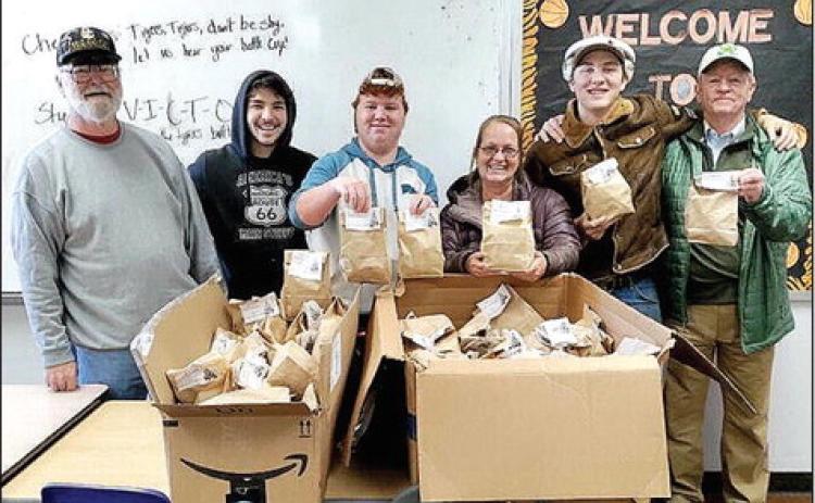The patrons of the Tribbey Senior Center collected donations of hats and gloves (or monetary donations) that ended Dec. 2. On Wednesday, Dec. 14 the items were presented to the Wanette School administration with a pair of gloves going to each student in the district. Photo provided