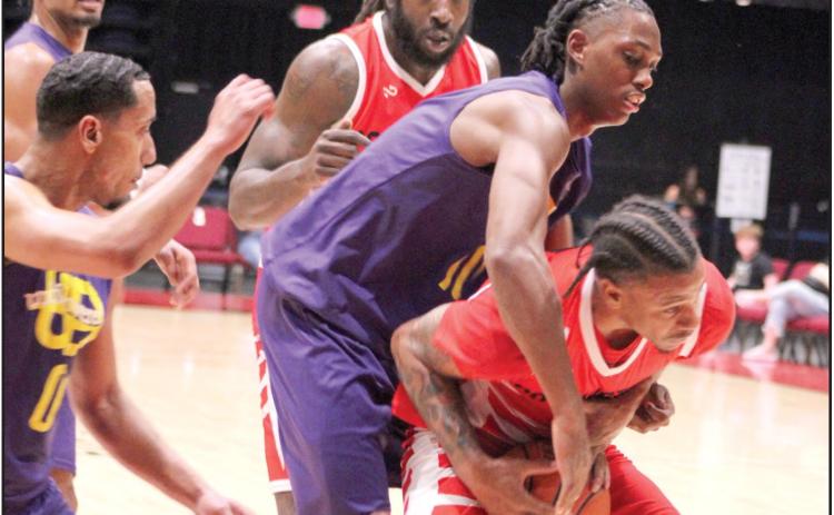 Potawatomi Fire Power Forward Ruston Hayward, of Houston, TX, fights for the rebound against a Creating Young Minds (CYM) defender in the fourth quarter of the Exhibition Game on Feb. 24.