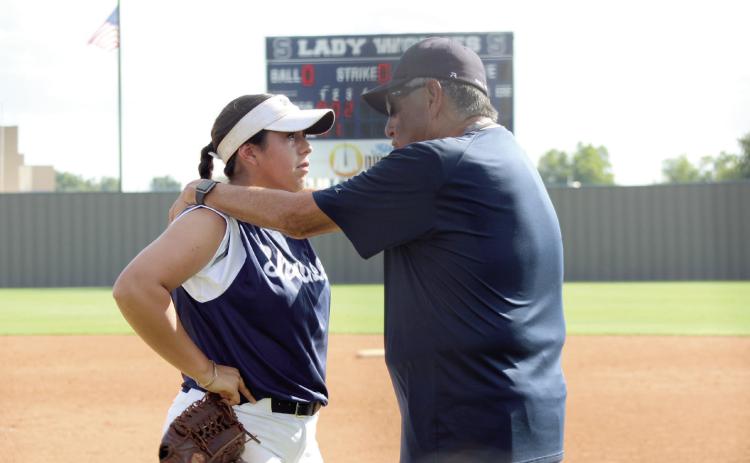 Shawnee's pitcher, Chochana Martin, consults with Coach Alex Flores during the home game against Putnam City North on Aug. 22. The Lady Wolves won, 7-5. Cheyanna Dietz, Countywide &amp; Sun