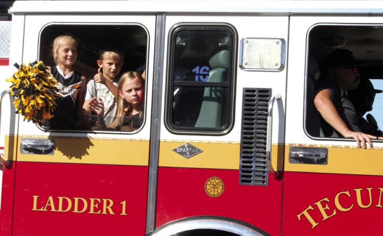 Children ride in a Tecumseh Fire Engine during the Frontier Days Parade on Sept. 30, 2023. File photo