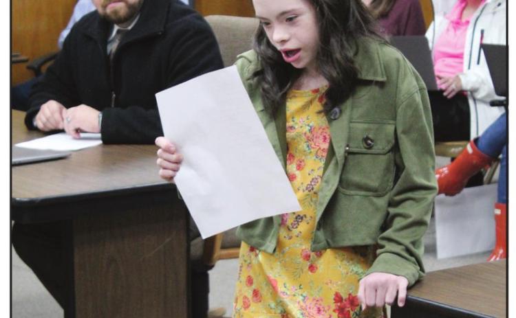 Shawnee sixth-grader Lilly Hennen reads a paragraph in the Potawatomi language and its English translation during the Shawnee Board of Education meeting on April 4. Countywide &amp; Sun/Natasha Dunagan